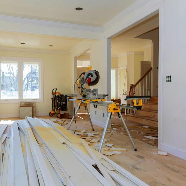 Circular saw cutting wooden trim on with on remodeling home