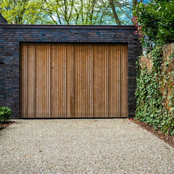 wide garage door and concrete driveway in front